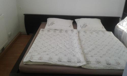 a bed with three white pillows on it at FeWo Ines in Lauscha