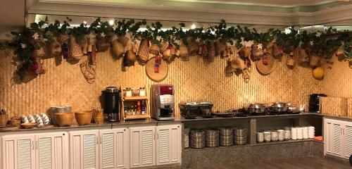 a kitchen with a bunch of meat hanging on the wall at Romance Hotel Sukhumvit 97 in Bangkok