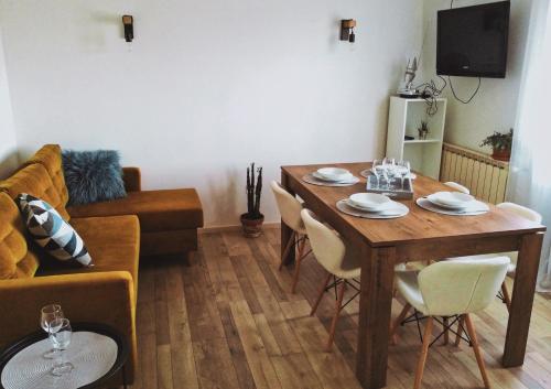 een woonkamer met een houten tafel en stoelen bij Apartment Gabi 2 in Umag