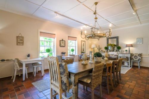 a dining room with a table and chairs at Oude Berg Guesthouse - 10 Caledon Street in George