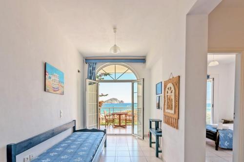 a room with a bed and a view of the ocean at Villa Panorama in Keri