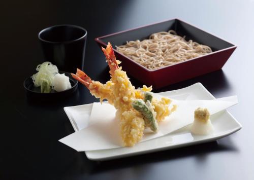 a plate of food with shrimp and a bowl of noodles at Hotel New Otani Tokyo Garden Tower in Tokyo