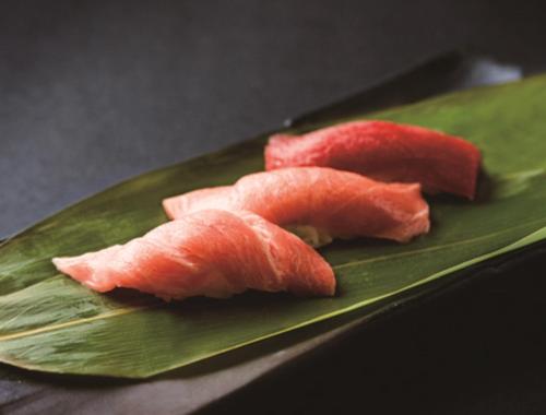 a green plate with three pieces of watermelon on it at Hotel New Otani Tokyo Garden Tower in Tokyo