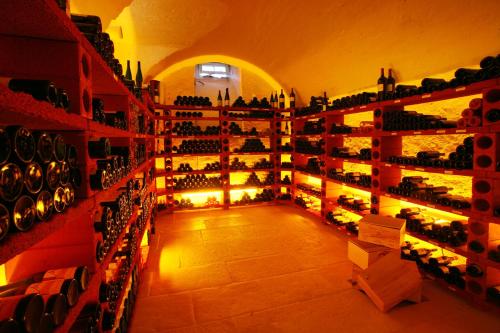 a wine cellar with lots of bottles of wine at Schloss Reinach in Freiburg im Breisgau