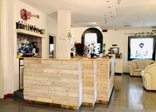 a restaurant with a wooden counter in a room at Hotel Garisenda B&B - in Centro a Riccione - in Riccione