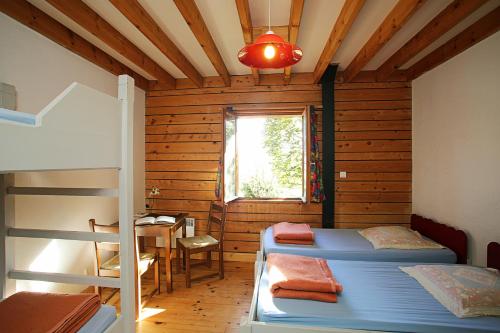 a room with two bunk beds and a table at Gîte Equisud - Demi-pension inclus in Les Angles