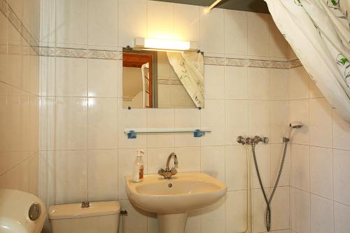 a bathroom with a sink and a toilet and a mirror at Gîte Equisud - Demi-pension inclus in Les Angles