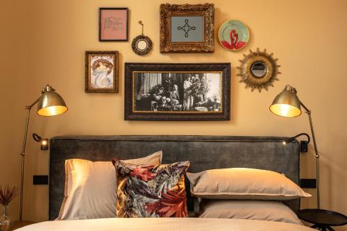 a bedroom with a bed and some pictures on the wall at Stella Suites Boutique Hotel in Goirle