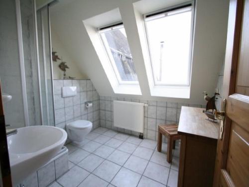 a bathroom with a sink toilet and a window at Margarethenhof in Tetenbüll