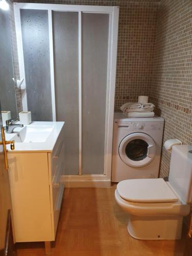 a small bathroom with a toilet and a sink at Apartamentos Mediterraneo in Marbella