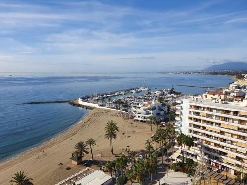 a beach with a large body of water at Apartamentos Mediterraneo in Marbella