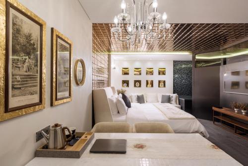 a bedroom with a bed and a table with a sink at Hotel The Designers Kondae in Seoul