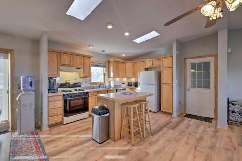a large kitchen with wooden cabinets and white appliances at Catskills Mtn Retreat with Panoramic View and Fire Pit in Cornwallville