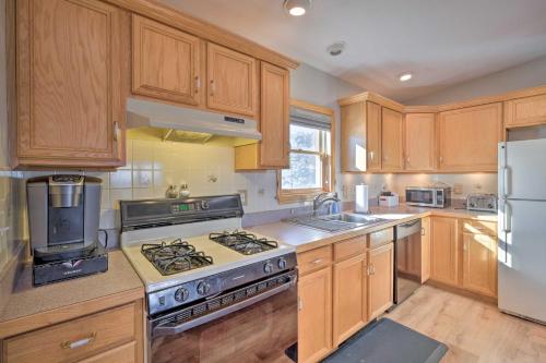 a kitchen with wooden cabinets and a stove top oven at Catskills Mtn Retreat with Panoramic View and Fire Pit in Cornwallville