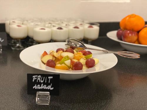 a plate of fruit on top of a table at Red & Blue Design Hotel Prague in Prague