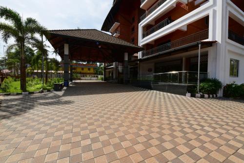 a building with a brick driveway in front of it at RNS ONE in Subrahmanya