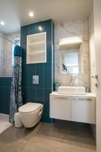 a bathroom with a toilet and a sink and a mirror at Gianni's house in Mastihari