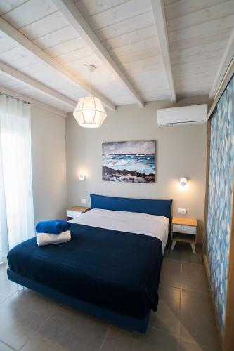 a bedroom with a large blue bed in a room at Gianni's house in Mastihari