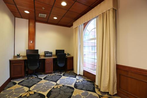 an office with a window and two desks and chairs at Wyndham Garden Grand Rapids Airport in Grand Rapids