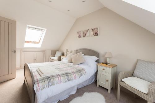 a bedroom with a bed and a chair at The Loft in Calne