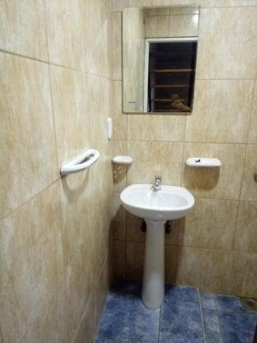 a bathroom with a sink and a mirror at Los Cabre in San Pedro