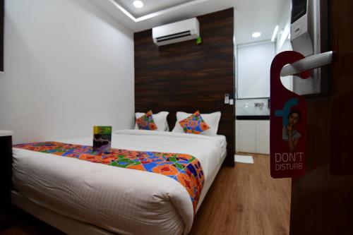 a hotel room with a bed and a sign that says dont justice at Hotel Om Stay Well in Indore