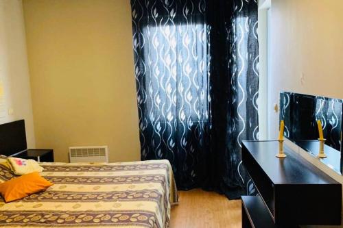 a bedroom with a bed and a black curtain at Orchidea 1 Bedroom Apartment in Sofia