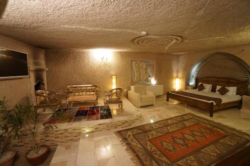 a large living room with a couch and a bed at Roma Cave Suite in Goreme