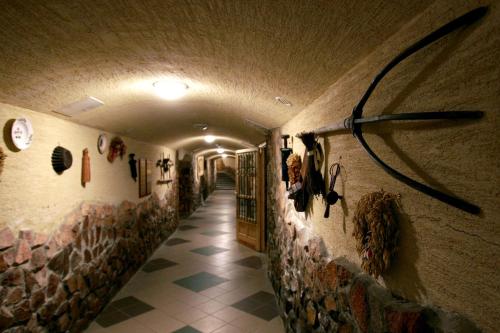 a hallway in a building with a wall with a fan at Hotel Szent István in Eger