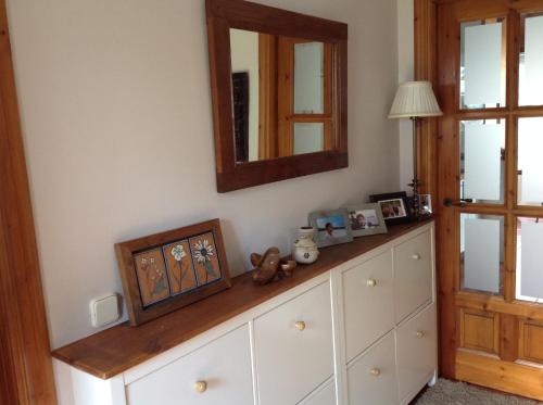 a room with a dresser with a mirror at Casa de la Tila in Arenas de Cabrales