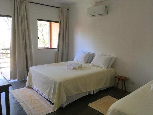 Ein Bett oder Betten in einem Zimmer der Unterkunft Pousada Mandala do Vale