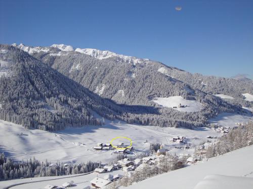 a ski resort in the snow with a mountain at Haus Annemarie Apartments Kartitsch - Hochpustertal in Kartitsch