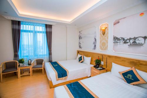 Giường trong phòng chung tại Melissa Hotel