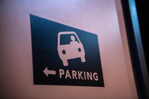 a sign on a door with a parking sign on it at ibis Styles Boulogne sur Mer Centre Cathédrale in Boulogne-sur-Mer