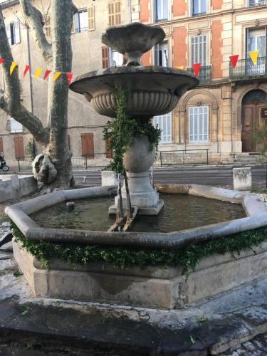 a large fountain in the middle of a street at LA CACHETTE ROMANTIQUE DU Jardin in Barjols