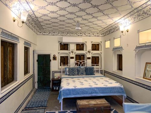 a bedroom with a bed and a coffered ceiling at Jaipur Haveli in Jaipur