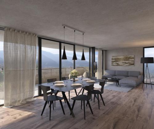 a dining room with a table and chairs and a couch at Marchegg Apartments in Naturno