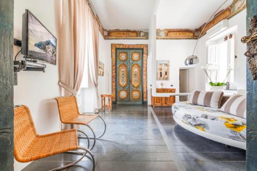 a living room filled with furniture and a large window at Hotel Palazzo Murat in Positano