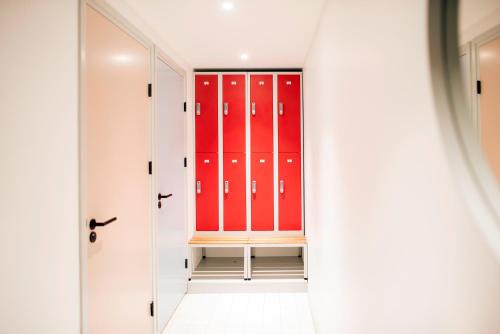 a locker room with red lockers at The Green Elephant Hostel & Spa in Maastricht