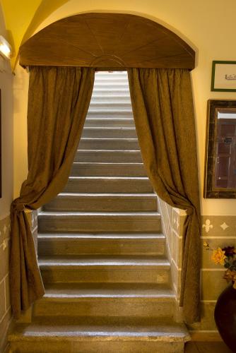 a set of stairs with a window and curtains at Hotel Rural La Casa De Pasarón in Pasarón