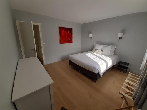 a bedroom with a bed and a red painting on the wall at La Méditation de Thaïs in Vertus