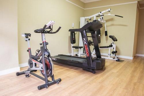 a gym with three exercise bikes in a room at San Juan Business São Paulo in São Paulo