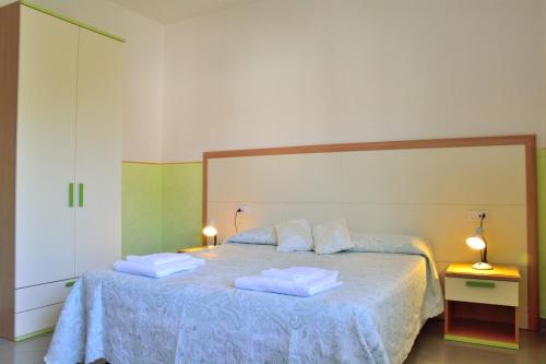 a bedroom with a bed with two towels on it at Residence Chiara in Chieti