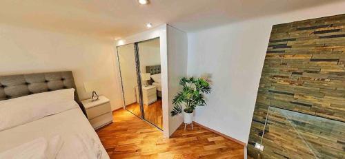 a bedroom with a mirror and a bed in a room at Zeus Design Loft Apartments in Vienna