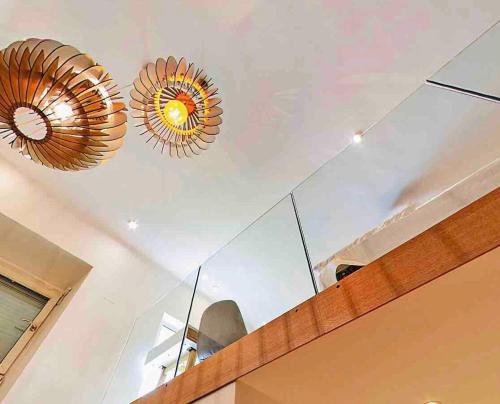 two chandeliers hanging from a ceiling in a room at Zeus Design Loft Apartments in Vienna