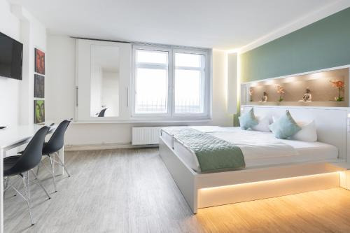 a bedroom with a bed with a desk and chairs at bedpark Stellingen in Hamburg