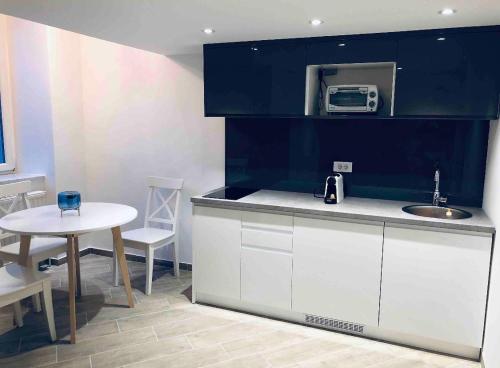 a kitchen with a counter and a table and a microwave at Zeus Design Loft Apartments in Vienna