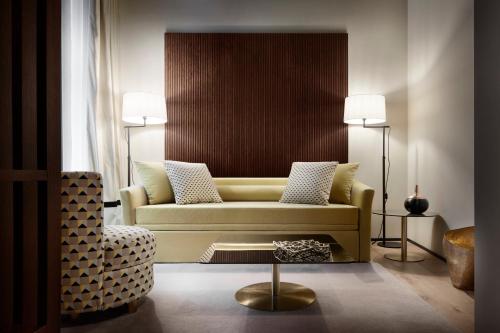 a living room with a couch and a chair at Speronari Suites in Milan
