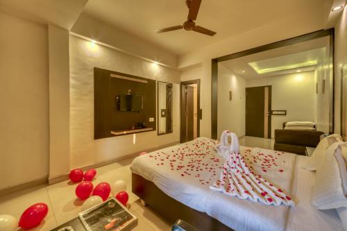a bedroom with a bed with red decorations on it at Hotel Ashwin Igatpuri, Pure Veg & Jain Food in Igatpuri