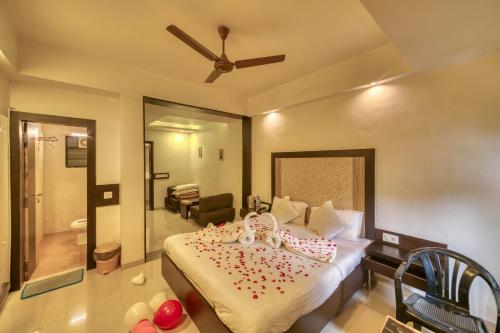 a bedroom with a bed with balloons on it at Hotel Ashwin Igatpuri, Pure Veg & Jain Food in Igatpuri